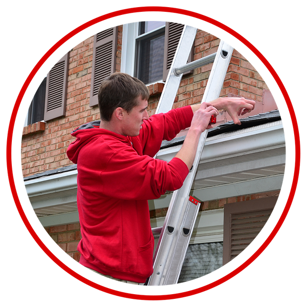  Image of a contractor clearing leaves and debris from gutters.