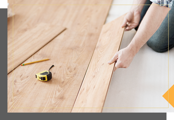 A person installing hardwood floors