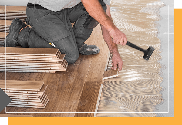 image of a man installing hardwood floors