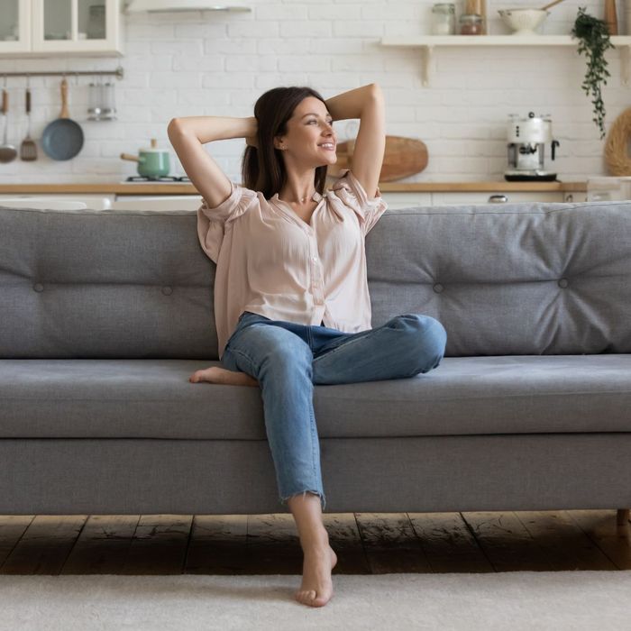 woman sitting on couch enjoying clean air