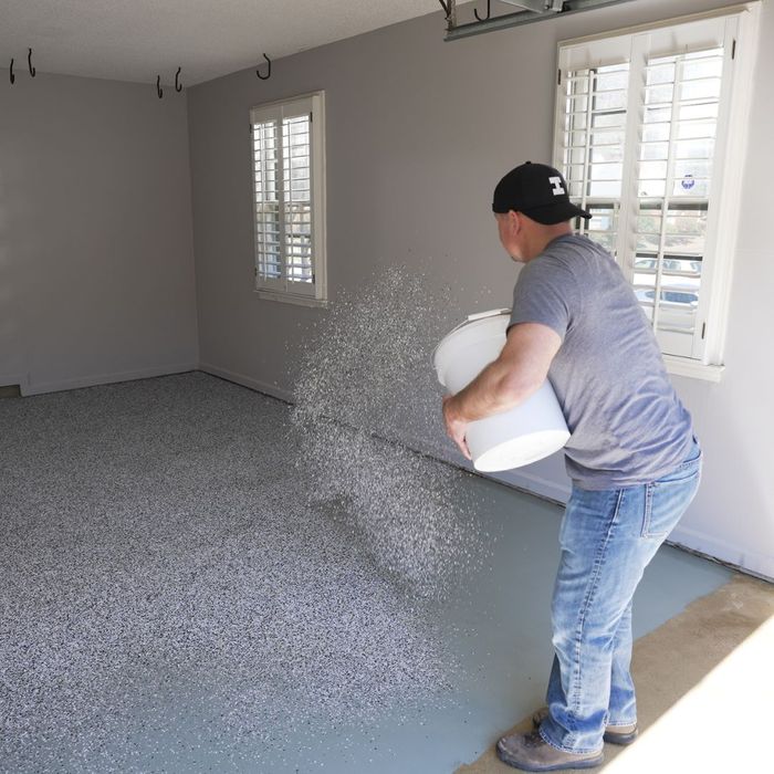 man customizing his epoxy floor