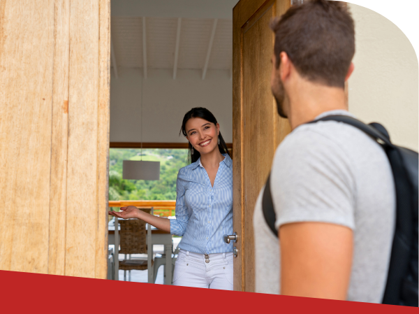 woman welcoming guest to guest house