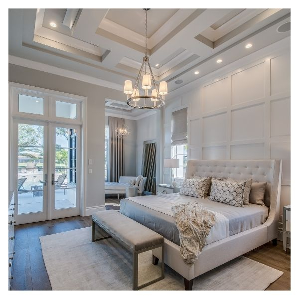 Elegant bedroom with chandelier and upholstered bed