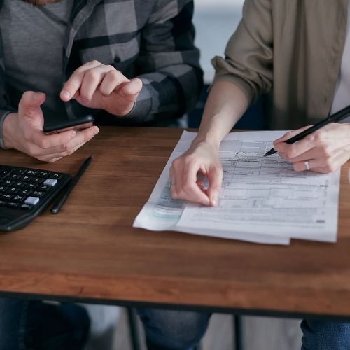 Man and woman working on their taxes
