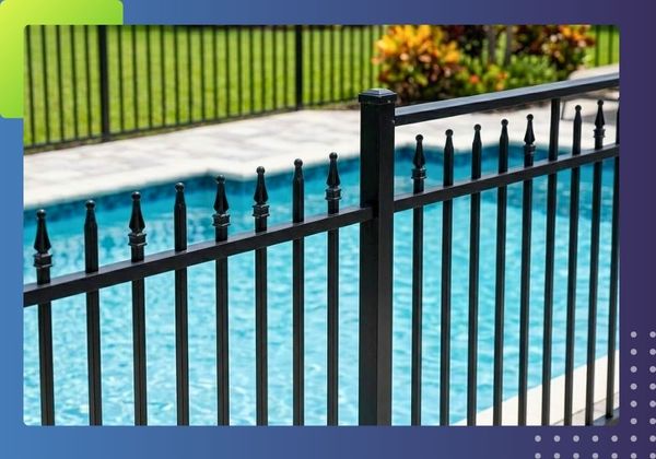 a section of sleek, black aluminum pool fencing encircling a sparkling blue swimming pool