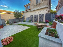 Landscape design with new grass, patio, and raised cement garden bed - Bonilla's Landscapes