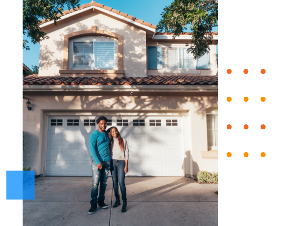 happy couple standing outside home