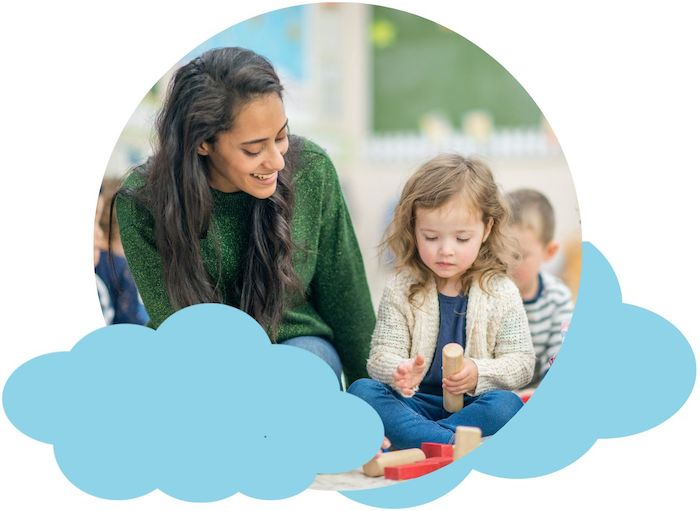 Early education teacher and toddler playing with blocks