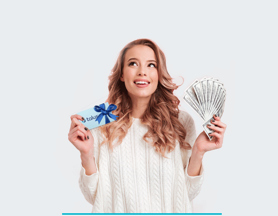 woman holding money and a gift card