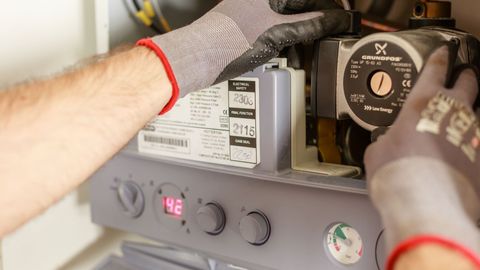 technician working on a furnace technician working on a furnace
