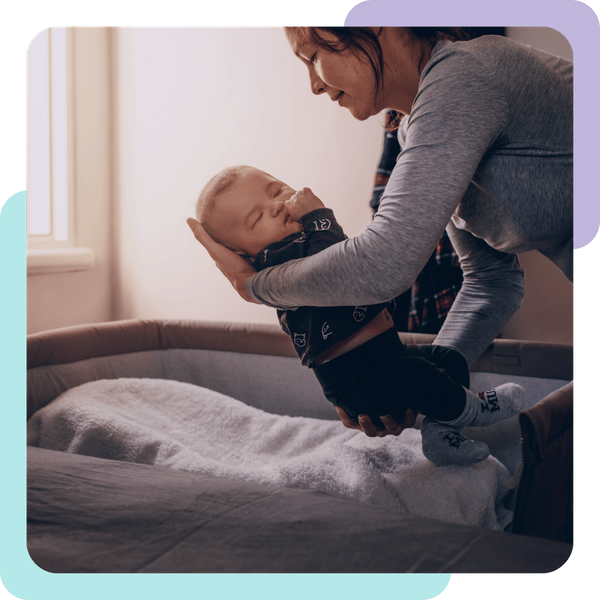 woman places baby in bassinet Hollister 3.png