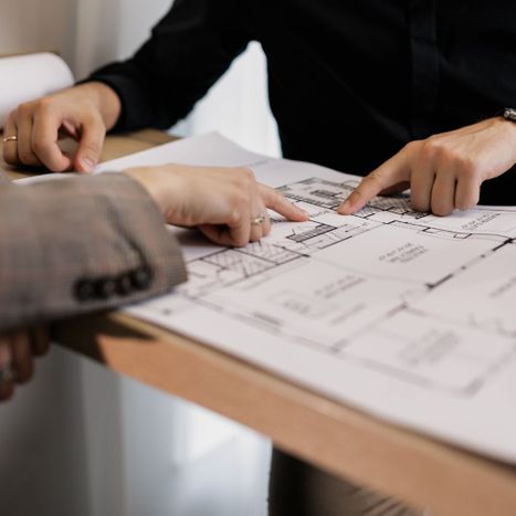 Two people looking over construction plans