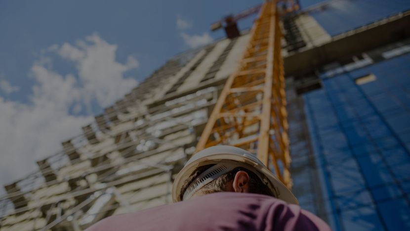 Person in front of a modern building under construction