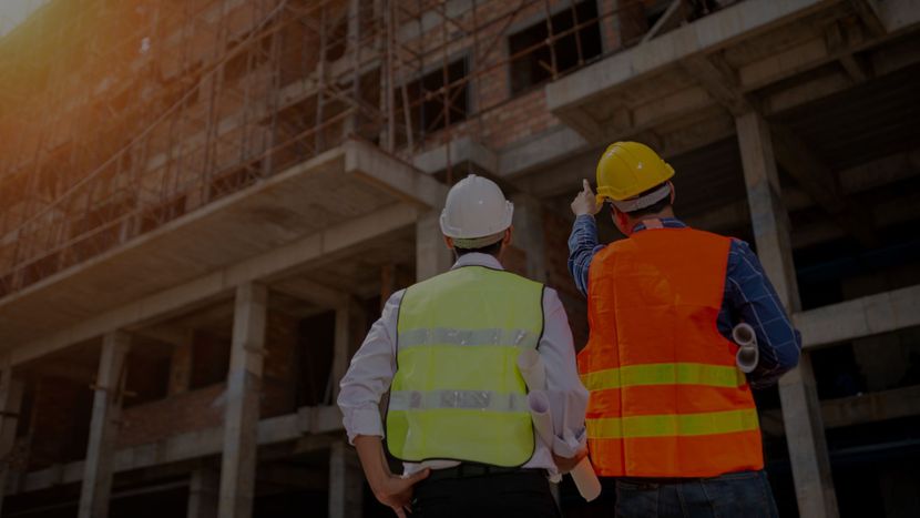 Two people looking at a building under construction