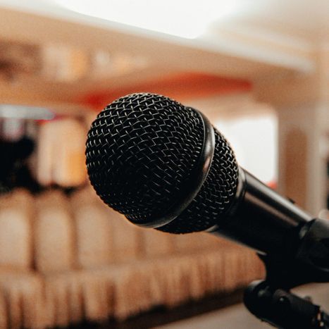 Microphone in front of lots of chairs in a meeting room