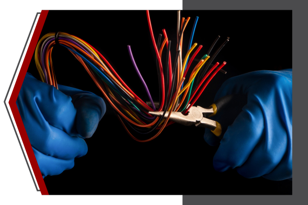 hands holding electric wires between plyers