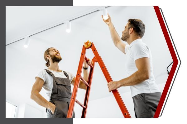 electricians installing lights in house