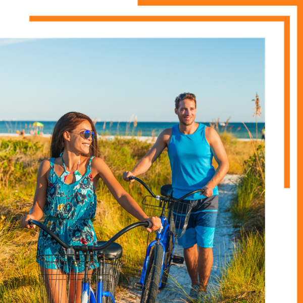 a couple with bikes on the beach