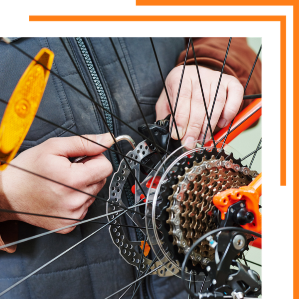 man working on bicycle gears