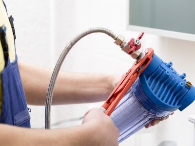 A sleek water filtration system in a modern kitchen. A sleek water filtration system in a modern kitchen.