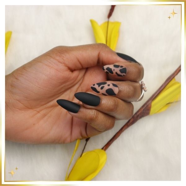 a woman's nails with expertly trimmed cuticles and design