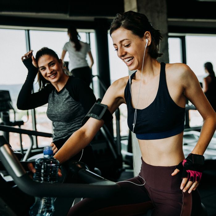women smiling while using the fitness center