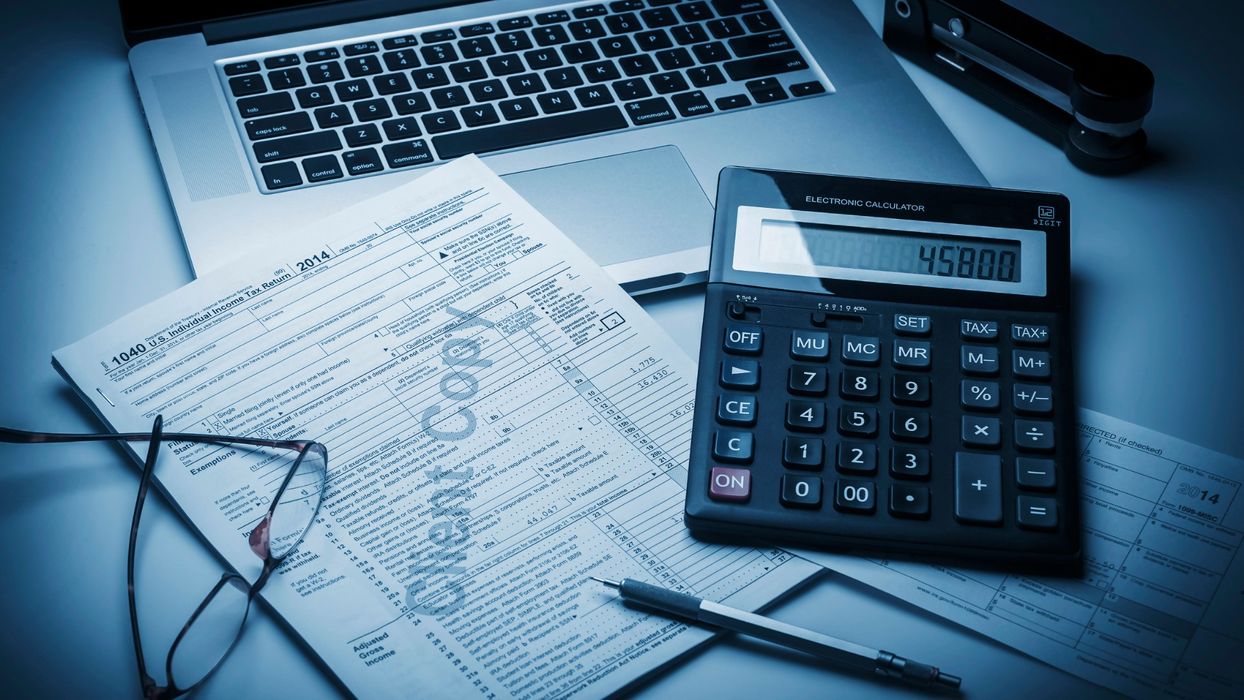 calculator and tax papers on desk