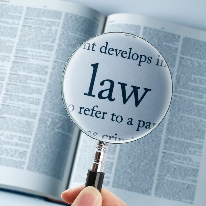 Magnifying glass over law book