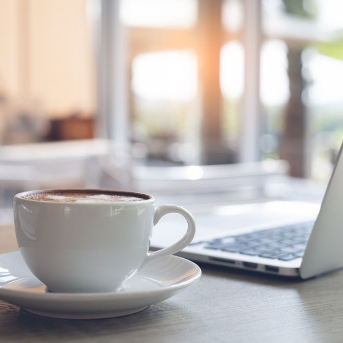 Coffee beside laptop