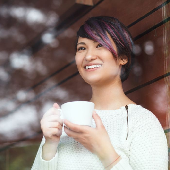 Woman standing outside with her coffee