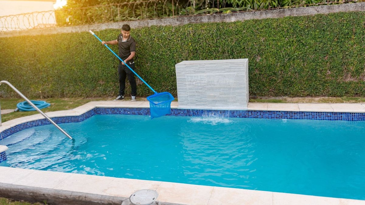 an outdoor pool getting cleaned