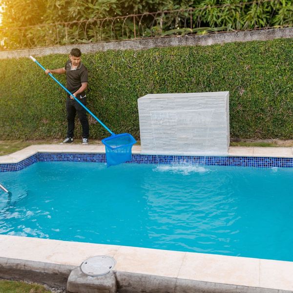 man cleaning swimming pool