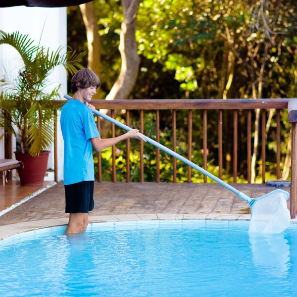 boy cleaning residential pool