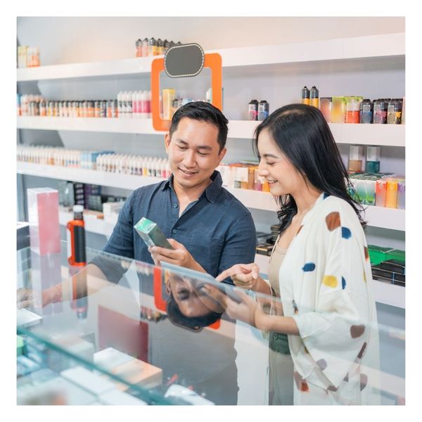 person getting advice from smoke shop worker