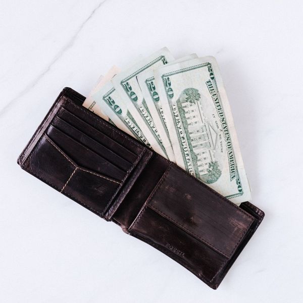 Open wallet with U.S. dollar bills sticking out