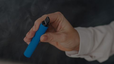 person holding a vape