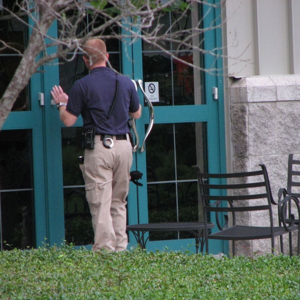 security officer looking through business window security officer looking through business window