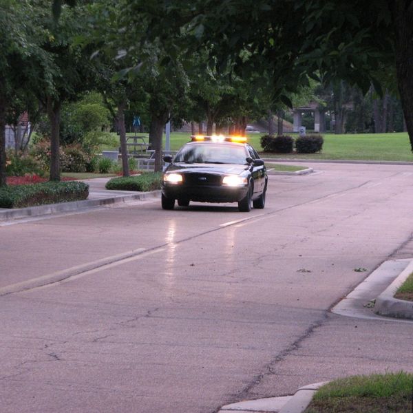 security officer patrol car driving down street security officer patrol car driving down street