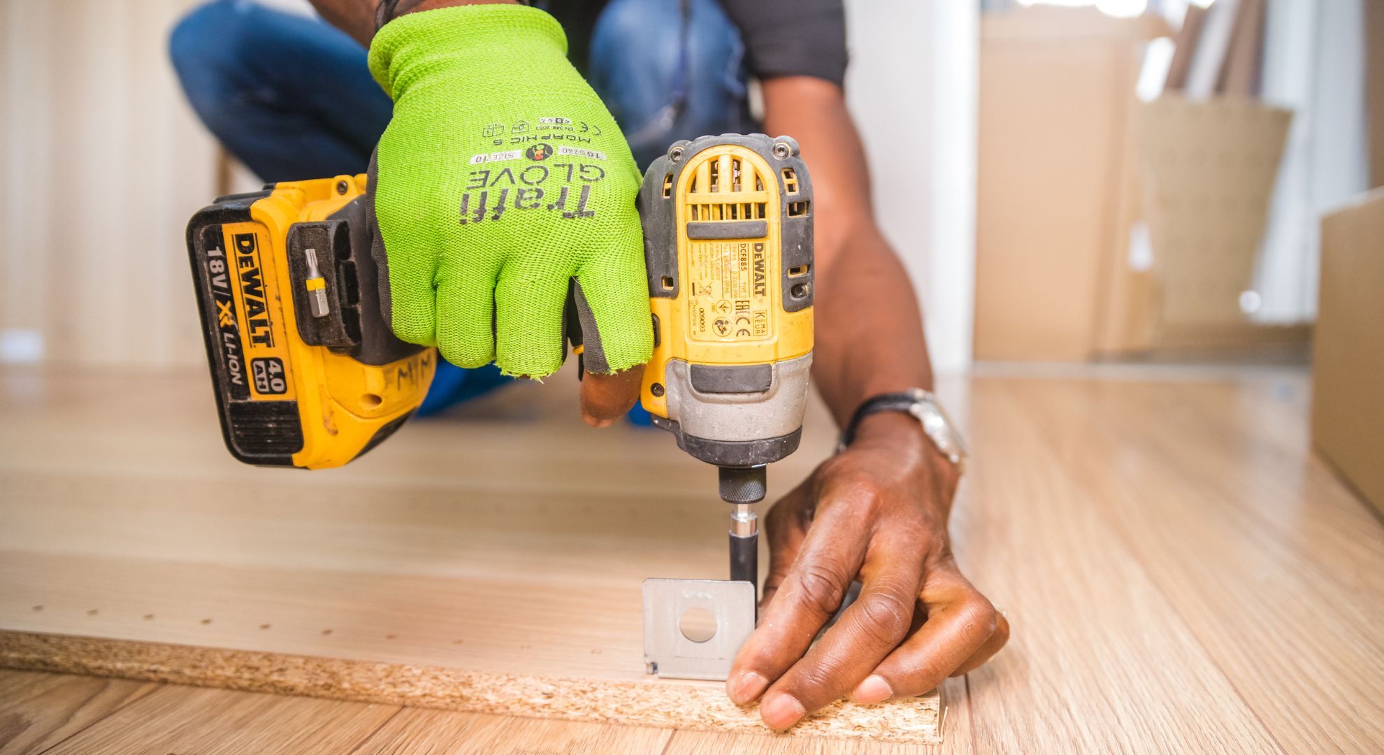 person using a drill on a wooden floor person using a drill on a wooden floor