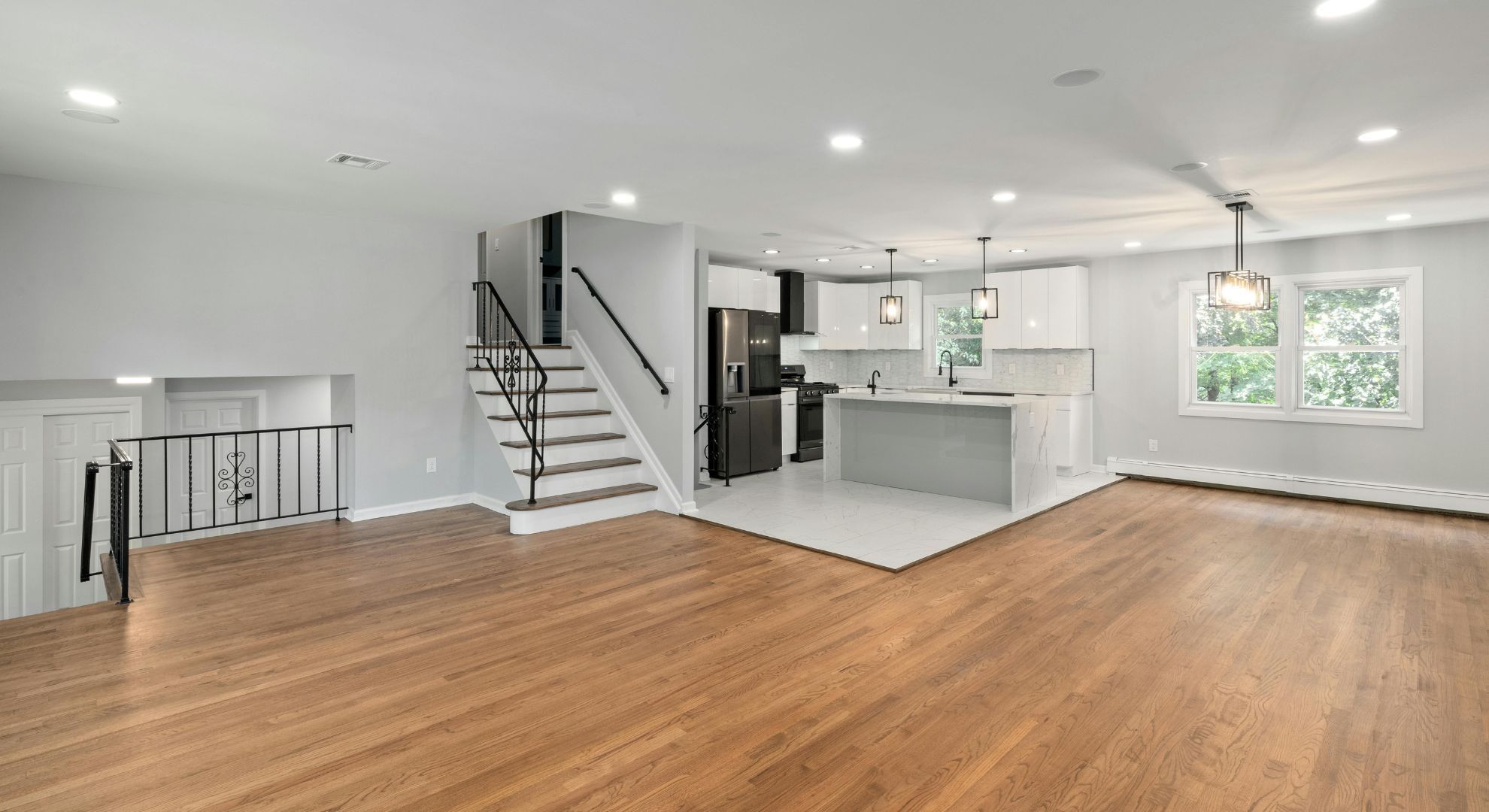 living room with wooden floors and kitchen living room with wooden floors and kitchen