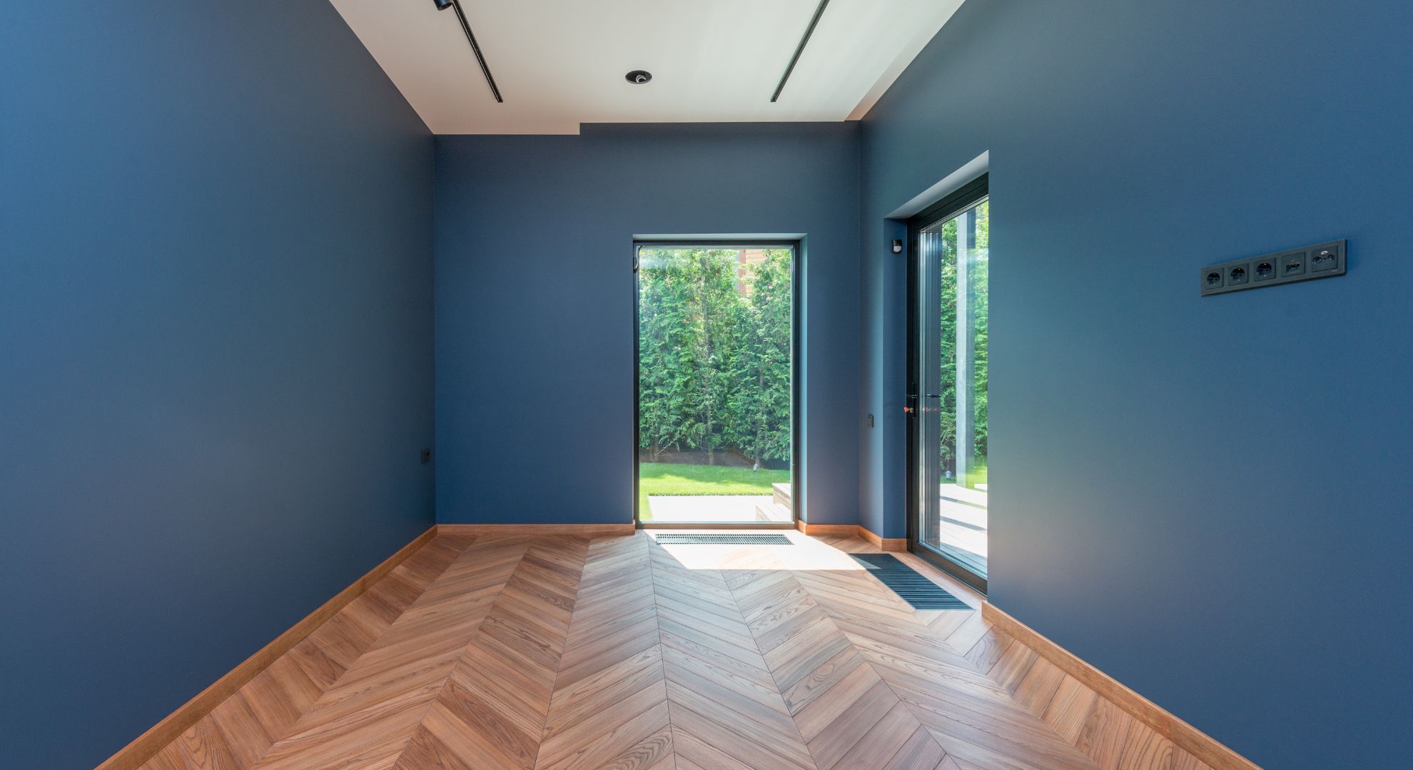 room with blue walls and a wooden floor room with blue walls and a wooden floor
