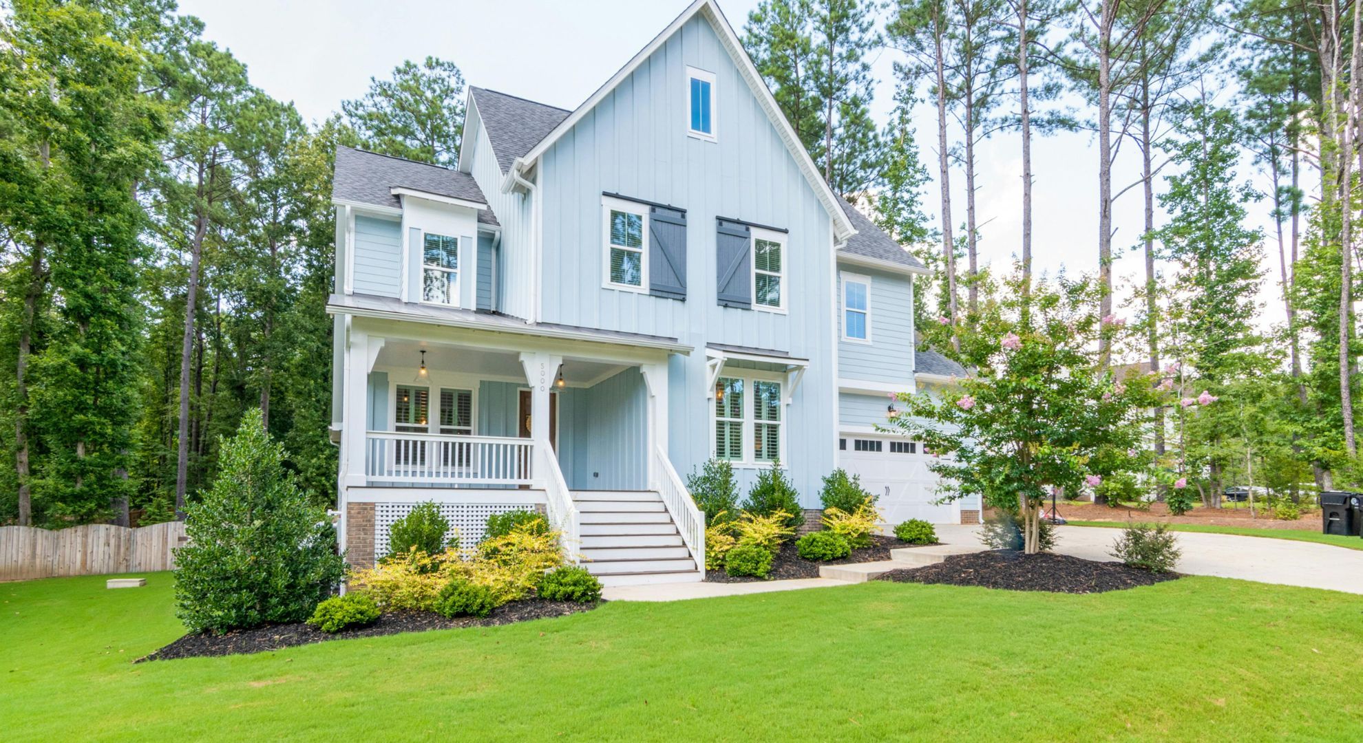 small white house with a lawn