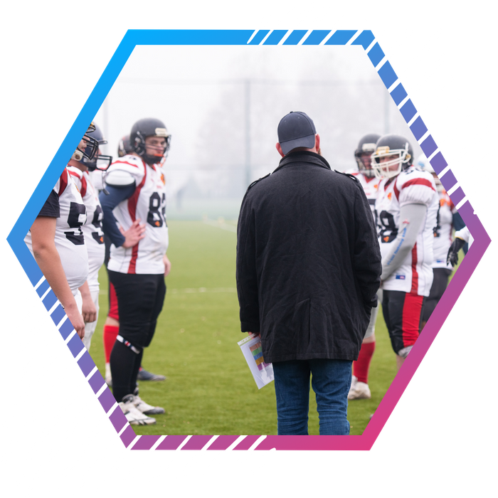 a football coach on the field with his team