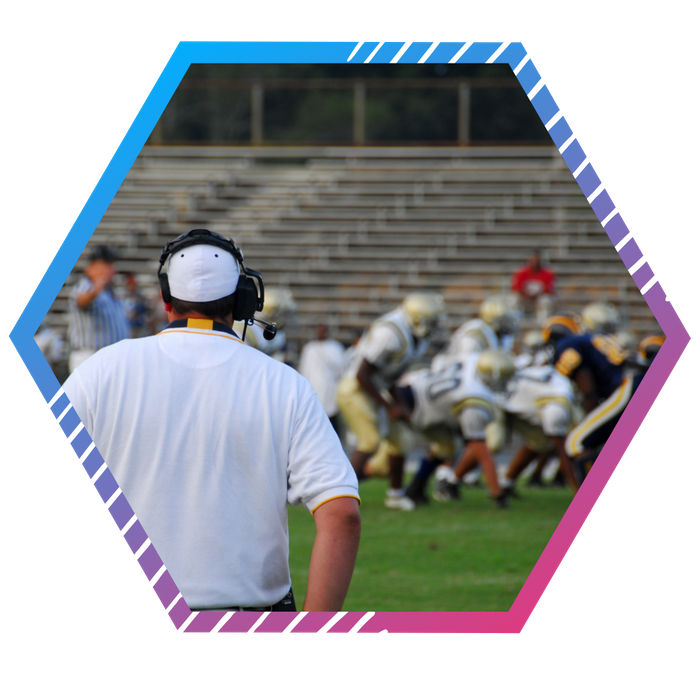 a football coach watching a game from the sidelines