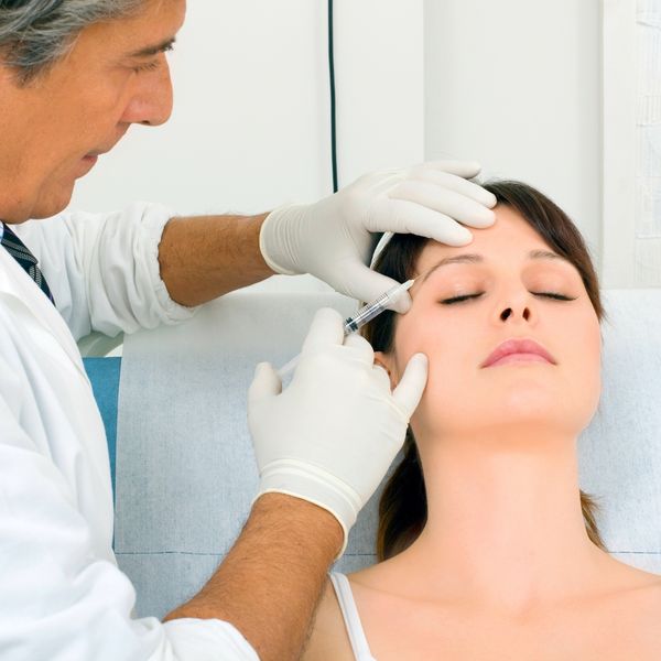 Woman getting Botox in her temple