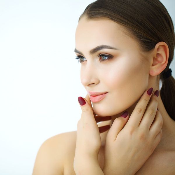 A woman touching her face