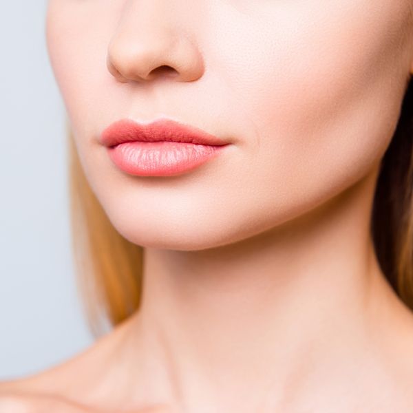 Woman's jaw with smooth skin and plump lips