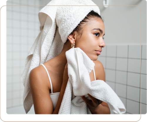 woman wiping face with towel