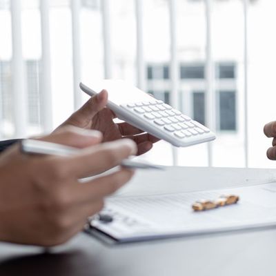 insurance agent showing number to client on calculator