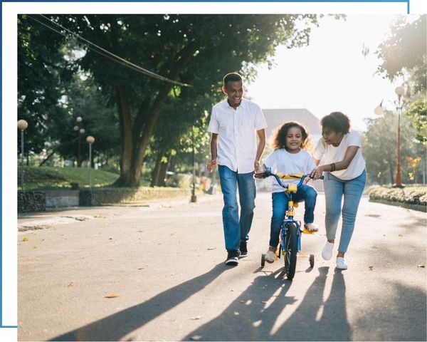 happy family with child riding bike